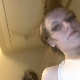 A pretty blonde girl records herself taking a painfully wide, hard, chunky shit from an under the ass perspective while bending over in front of a toilet. Presented in 720P HD. About a minute.